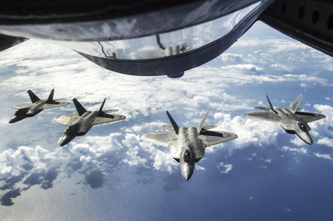 Four F-22 Raptors await refueling from a KC-135R Stratotanker aircraft during Rim of the Pacific 2016 over the Pacific Ocean, July 26, 2016. The Raptor pilots are assigned to the 199th and 19th Fighter squadrons. The Stratotanker crew is assigned to the 465th Air Refueling Squadron. Navy photo by Petty Officer 2nd Class Gregory A. Harden II