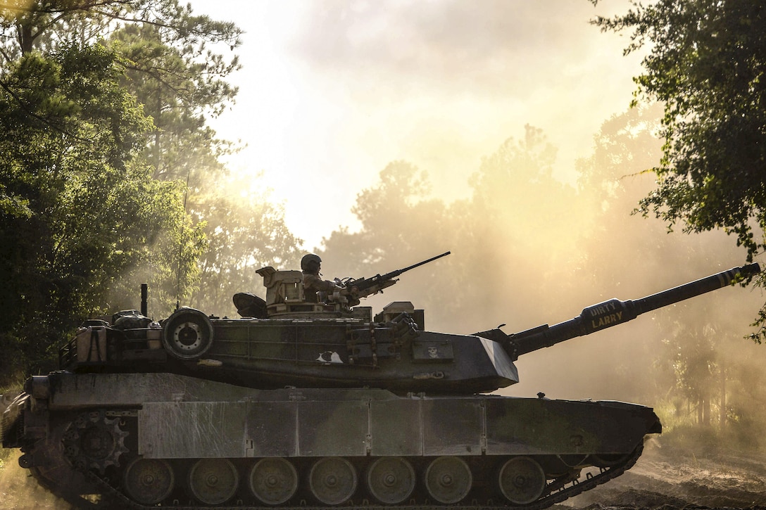 An M1A1 Abrams tank drives down a dirt road during a training event on Camp Lejeune, N.C., July 21, 2016. The event brought together active and reserve Marines to train for possible future deployment. Marine Corps photo by Sgt. Matthew Callahan