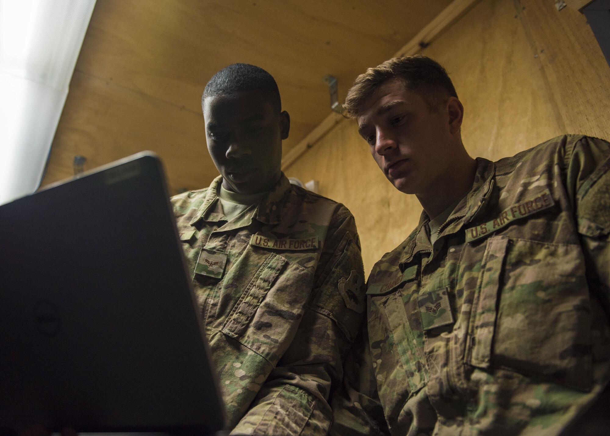 Senior Airman Isiah Chaney and Airman 1st Class Reginald Maffett, 455th Expeditionary Communications Squadron, network management technicians, program a network switch, Bagram Airfield, Afghanistan, July 29, 2016. Switches connect devices together on a network, and receive, process and forward data to computers. (U.S. Air Force photo by Senior Airman Justyn M. Freeman)