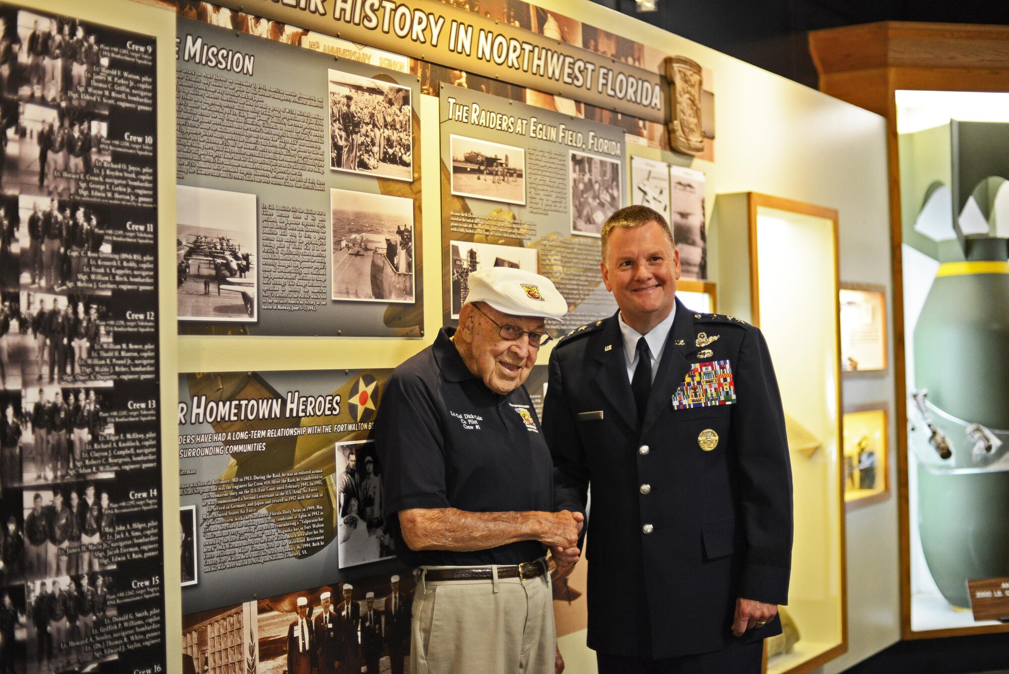 Lt. Col. (ret.) Richard “Dick” Cole greets Lt. Gen. Brad Webb, commander of Air Force Special Operations Command at the Doolittle Raider’s exhibit July 30, 2016 at the U.S. Air Force Armament Museum on Eglin Air Force Base, Fla. Webb spoke at the ceremony and highlighted the importance of Cole and his history as one of the founding members of the 1st Air Commando Group. (U.S. Air Force photo/Staff Sgt. Melanie Holochwost)