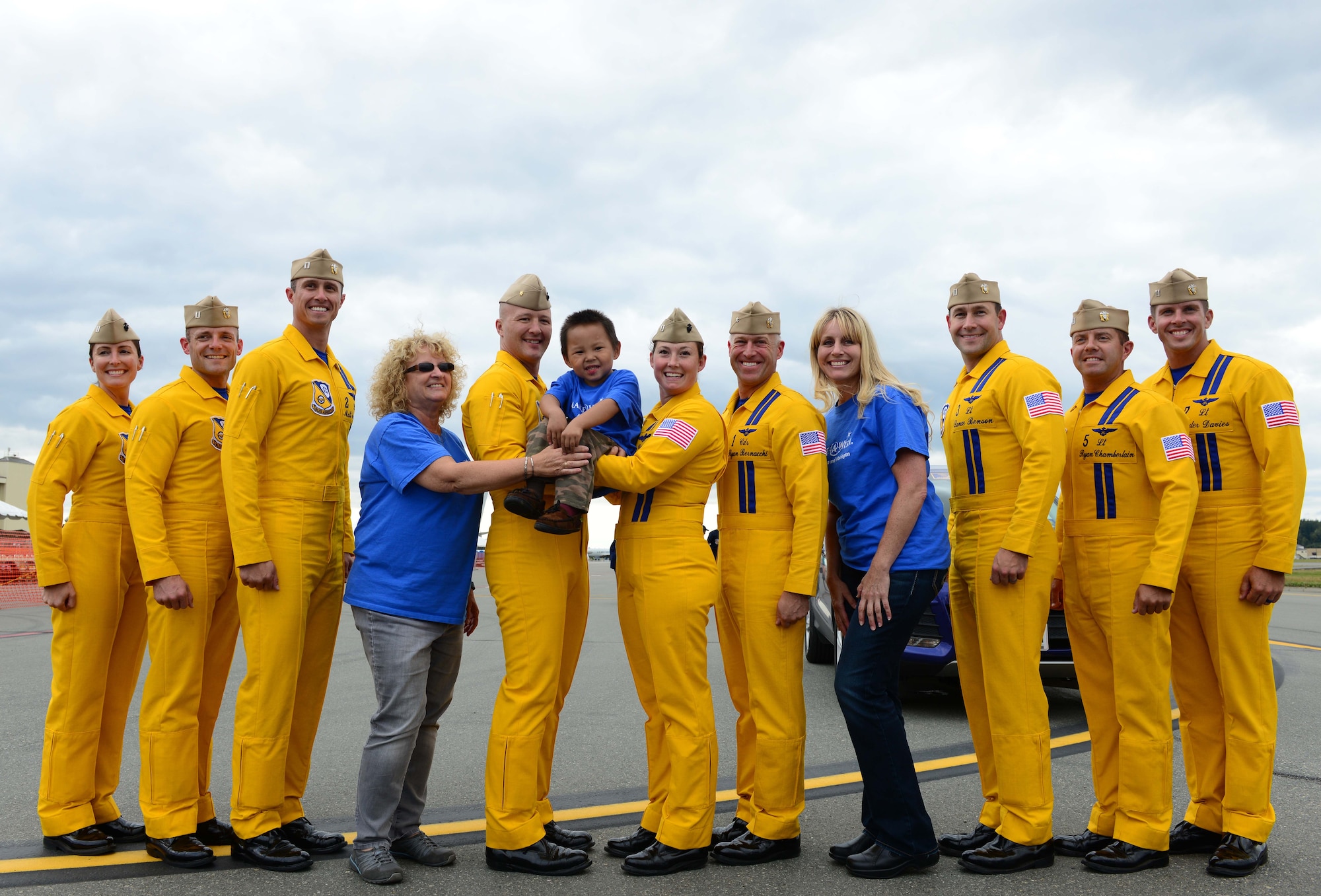 Thomas Sagoonick, 4, and family take a photo with members from the U.S. Navy Flight Demonstration Squadron, the Blue Angels during Arctic Thunder Special Needs and Family Day, July 29, 2016. JBER will open the doors to the public, showcasing more than 40 key performers and ground acts to include the JBER joint forces, U.S. Air Force F-22, and U.S. Navy Blue Angels demonstrations teams. (U.S Air Force photo by Airman 1st Class Javier Alvarez)