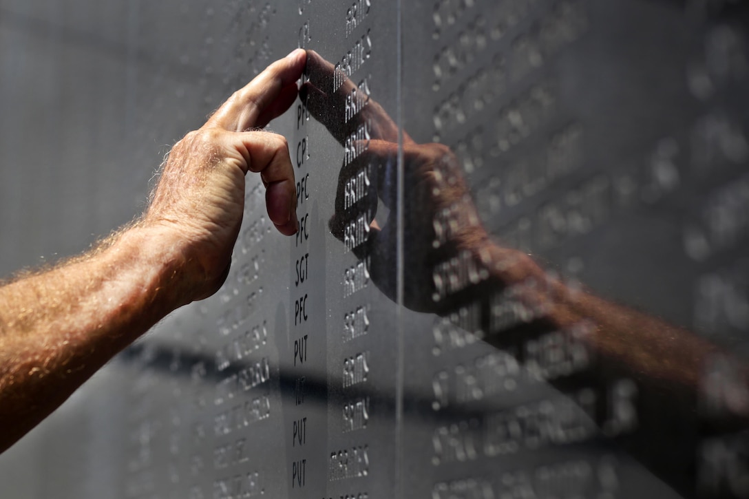 A Korean War veteran looks for the name of a fallen comrade during the National Korean War Veterans Armistice Day ceremony at the New Jersey Korean Veterans War Memorial in Brighton Park, Atlantic City, N.J., July 27, 2016. Air National Guard photo by Tech. Sgt. Matt Hecht