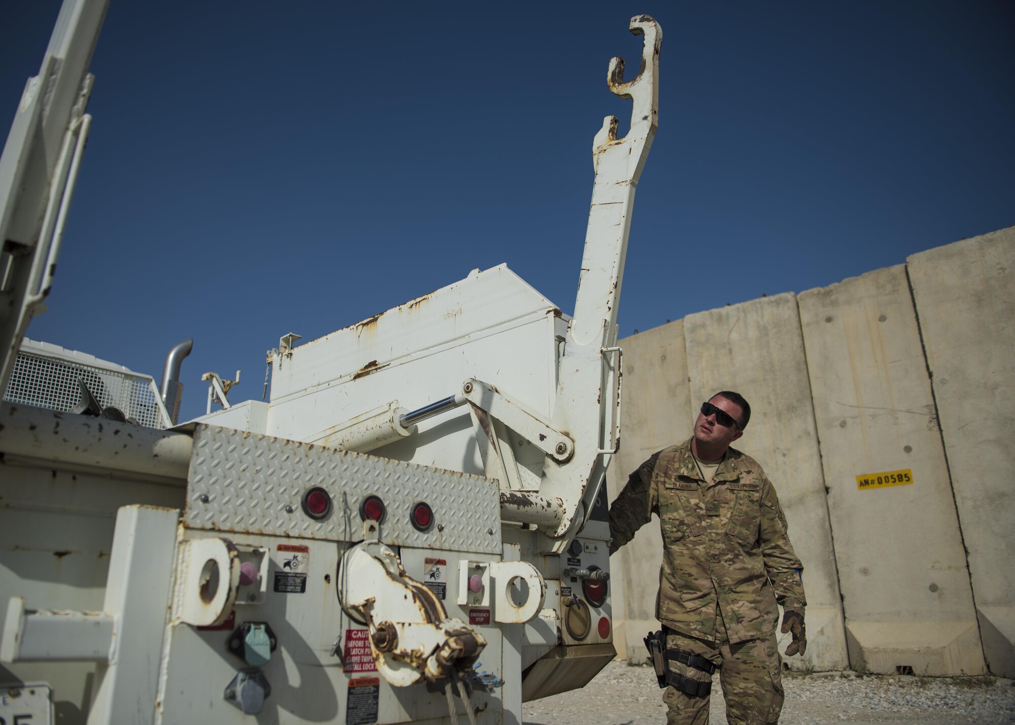 Staff Sgt. Corey Blanar, 455th Expeditionary Communications Squadron, cable and antenna maintenance noncommissioned officer in charge, lowers a cable reel lift, Bagram Airfield, Afghanistan, July 30, 2016. Cable and antenna maintenance technicians install, maintain and modify copper core, coaxial, waveguide and fiber optic cable and antenna systems. (U.S. Air Force photo by Senior Airman Justyn M. Freeman)
