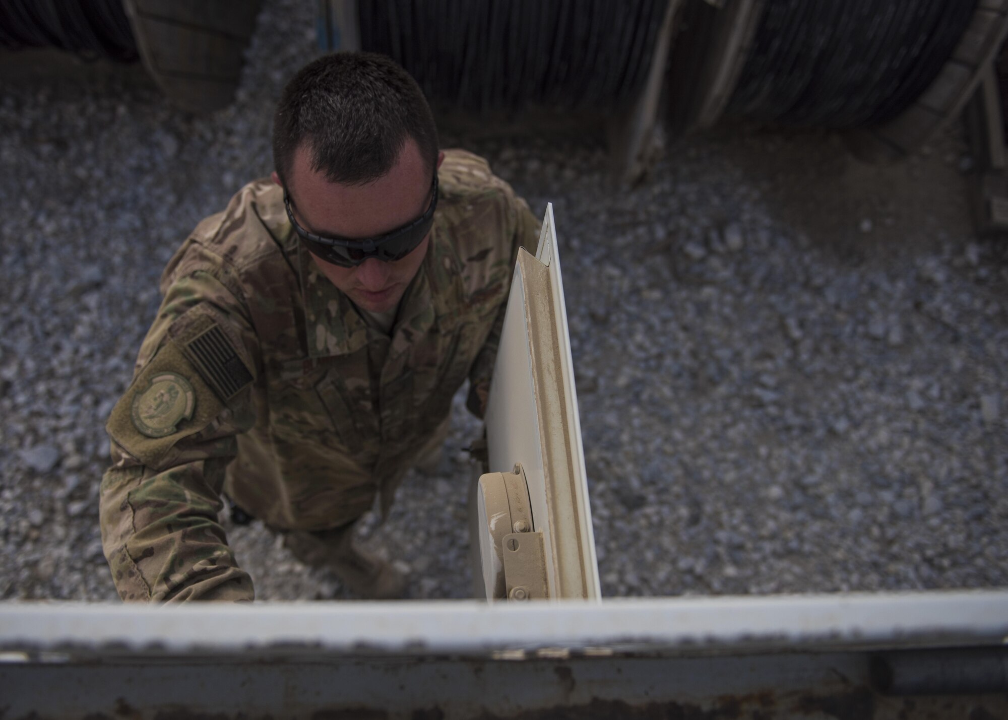 Staff Sgt. Corey Blanar, 455th Expeditionary Communications Squadron, cable and antenna maintenance noncommissioned officer in charge, checks the control panel on a cable reel truck, Bagram Airfield, Afghanistan, July 30, 2016. Cable and antenna technicians monitor and analyze the performance of underground, buried, and aerial cable and antenna networks. They ensure Bagram personnel maintain the ability to monitor missions and communicate with each other. (U.S. Air Force photo by Senior Airman Justyn M. Freeman)