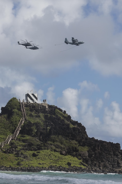 160730-M-GA922-1097 MARINE CORPS BASE, HAWAII (July 30, 2016) - A U.S. Marine Corps KC-130J Hercules and two CH-53E Super Stallions conduct a refueling exercise during Rim of the Pacific 2016. Twenty-six nations, more than 40 ships and submarines, more than 200 aircraft and 25,000 personnel are participating in RIMPAC from June 30 to Aug. 4, in and around the Hawaiian Islands and Southern California. The world's largest international maritime exercise, RIMPAC provides a unique training opportunity that helps participants foster and sustain the cooperative relationships that are critical to ensuring the safety of sea lanes and security in the world's oceans. RIMPAC 2016 is the 25th exercise in the series that began in 1971. (U.S. Marine Corps photo by Lance Cpl. Matthew Casbarro)