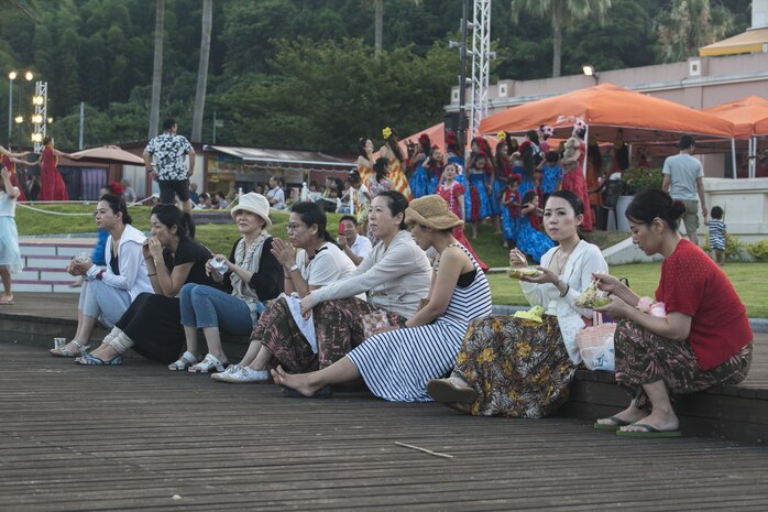 Japanese locals enjoy some of the foods served at the U.S. – Japan Luau Party on Oshima Island, Japan, July 23, 2016. Residents of Marine Corps Air Station Iwakuni visited the island of Oshima to join in celebration of the island’s history and the bond between the U.S. and Japan. (U.S. Marine Corps photo by Cpl. Nathan Wicks)