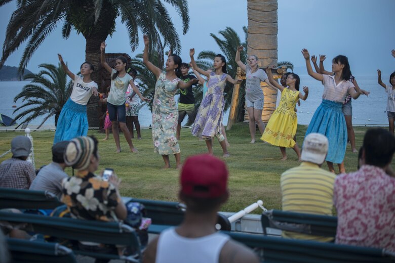 Residents of Marine Corps Air Station Iwakuni participate in the Hawaiian festivities by hula dancing during the U.S. – Japan Luau Party on Oshima Island, Japan, July 23, 2016. Residents of Marine Corps Air Station Iwakuni visited the island of Oshima to join in celebration of the island’s history and the bond between the U.S. and Japan. (U.S. Marine Corps photo by Cpl. Nathan Wicks)