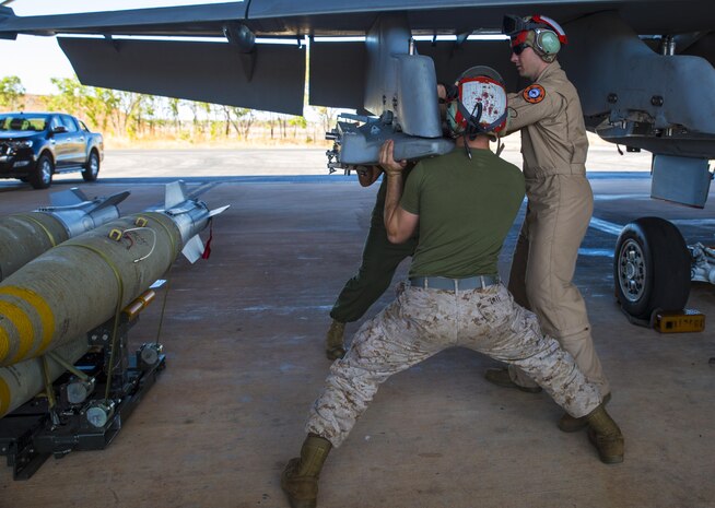 Staff Sgt. Jerrod Gelbaugh, the ordnance staff noncommissioned officer in charge with Marine Fighter Attack Squadron (VMFA) 122, assists Cpl. Mark Tate, an aviation ordnance technician with VMFA-122, remove a Bomb Rack Unit 55 from an F/A-18C during exercise Southern Frontier at Royal Australian Air Force Base Tindal, Australia, July 28, 2016. Southern Frontier is three weeks of unit level training helping the squadron gain experience and qualifications in low altitude, air-ground, high explosive ordnance delivery at the unit level. VMFA-122 is home based out of Marine Corps Air Station Beaufort, South Carolina and are currently assigned to MAG-12 at MCAS Iwakuni under the Unit Deployment Program.  Australia is the last stop on the squadron’s deployment before heading back home.  (U.S. Marine Corps photo by Cpl. Nicole Zurbrugg)