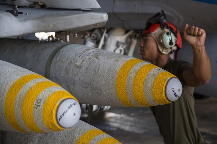 Cpl. Javon Franklin, an aviation ordnance technician with Marine Fighter Attack Squadron (VMFA) 122, assists in loading high explosive ordnance on an F/A-18C Hornet during exercise Southern Frontier at Royal Australian Air Force Base Tindal, Australia, July 28, 2016. Southern Frontier is three weeks of unit level training helping the squadron gain experience and qualifications in low altitude, air-ground, high explosive ordnance delivery at the unit level. VMFA-122 is home based out of Marine Corps Air Station Beaufort, South Carolina and are currently assigned to MAG-12 at MCAS Iwakuni under the Unit Deployment Program.  Australia is the last stop on the squadron’s deployment before heading back home.   (U.S. Marine Corps photo by Cpl. Nicole Zurbrugg)