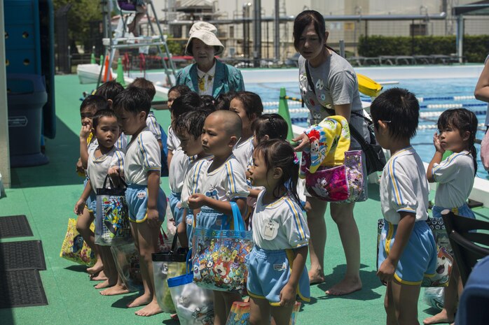 Students of Iwakuni-Kawashimo Kindergarten listen to a safety during a school visit at Marine Corps Air Station Iwakuni, Japan, July 21, 2016. The school visit is a time honored tradition between the base and the local community and holds a lasting memory with the visiting students. (U.S. Marine Corps photo by Cpl. Nathan Wicks)