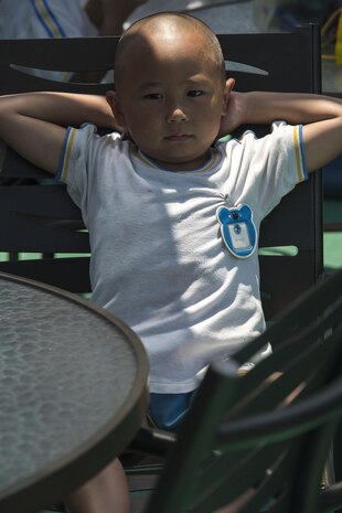 A student of Iwakuni-Kawashimo Kindergarten relaxes pool-side during a school visit at Marine Corps Air Station Iwakuni, Japan, July 21, 2016. The school visit is a time honored tradition between the base and the local community and holds a lasting memory with the visiting students. (U.S. Marine Corps photo by Cpl. Nathan Wicks)