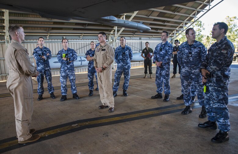 U.S Marine Corps Cpl. Jesse Meyers, a power liner with Marine Fighter Attack Squadron (VMFA) 122, gives a familiarization class to Cpl. Michael Barton, an aircraft rescue firefighter specialist with Marine Wing Support Squadron (MWSS) 171, and the No. 17 Squadron Fire and Rescue team at Royal Australian Air Force Base Tindal, Australia, July 28, 2016. Barton is a liaison between VMFA-122 and No. 17 Squadron firefighters in case of emergencies involving the flying squadron’s aircraft during Exercise Pitch Black 2016. The familiarization class covered the basic dos and don’ts of operating around the aircraft during an emergency to ensure a safe and successful recovery. (U.S. Marine Corps photo by Cpl. Nicole Zurbrugg)