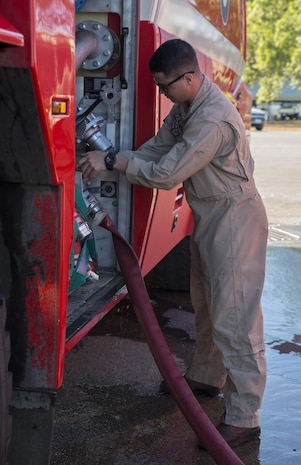 U.S. Marine Corps Cpl. Michael Barton, an aircraft rescue firefighter specialist with Marine Wing Support Squadron (MWSS) 171, refills a fire truck during Exercise Pitch Black 2016 at Royal Australian Air Force Base Tindal, Australia, July 28, 2016. Barton is a liaison between Marine Fighter Attack Squadron (VMFA) 122 and No. 17 Squadron Fire and Rescue team stationed at RAAF Tindal in case of emergencies with the flying squadron’s aircraft during the exercise. Pitch Black is a multination exercise that includes participation from Canada, France, Italy, Germany, Indonesia, Netherlands, New Zealand, Singapore and Thailand. (U.S. Marine Corps photo by Cpl. Nicole Zurbrugg)