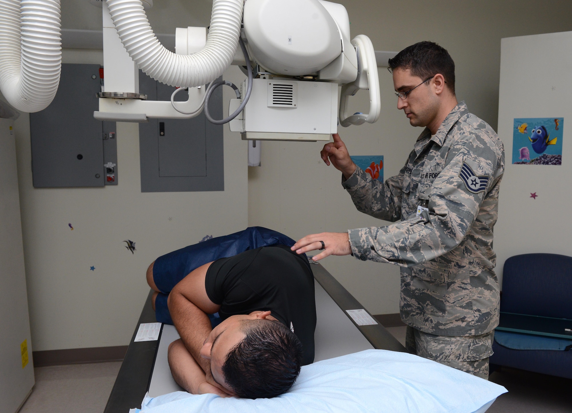 Staff Sgt. Scott Hoppe, 36th Medical Support Squadron diagnostic imaging technician, prepares to take an X-ray scan of a patient May 23, 2016, at Andersen Air Force Base, Guam. X-rays taken at the radiology department are used to assist the doctors with their diagnoses. (U.S. Air Force photo by Airman 1st Class Arielle Vasquez/Released) 