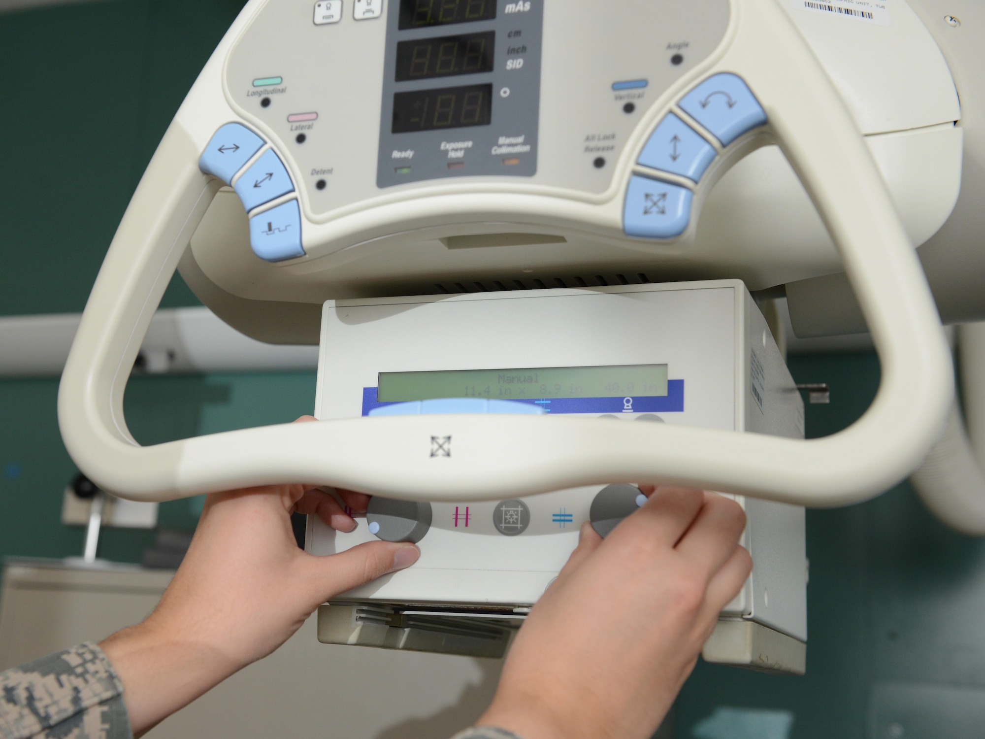 Tech. Sgt. Tianna Weymer, 36th Medical Support Squadron diagnostic imaging NCO in charge of the radiology department, adjusts settings on an X-ray machine May 24, 2016, at Andersen Air Force Base, Guam. Airmen use the machine to determine the field of exposure on a patient. (U.S. Air Force photo by Airman 1st Class Arielle Vasquez/Released)