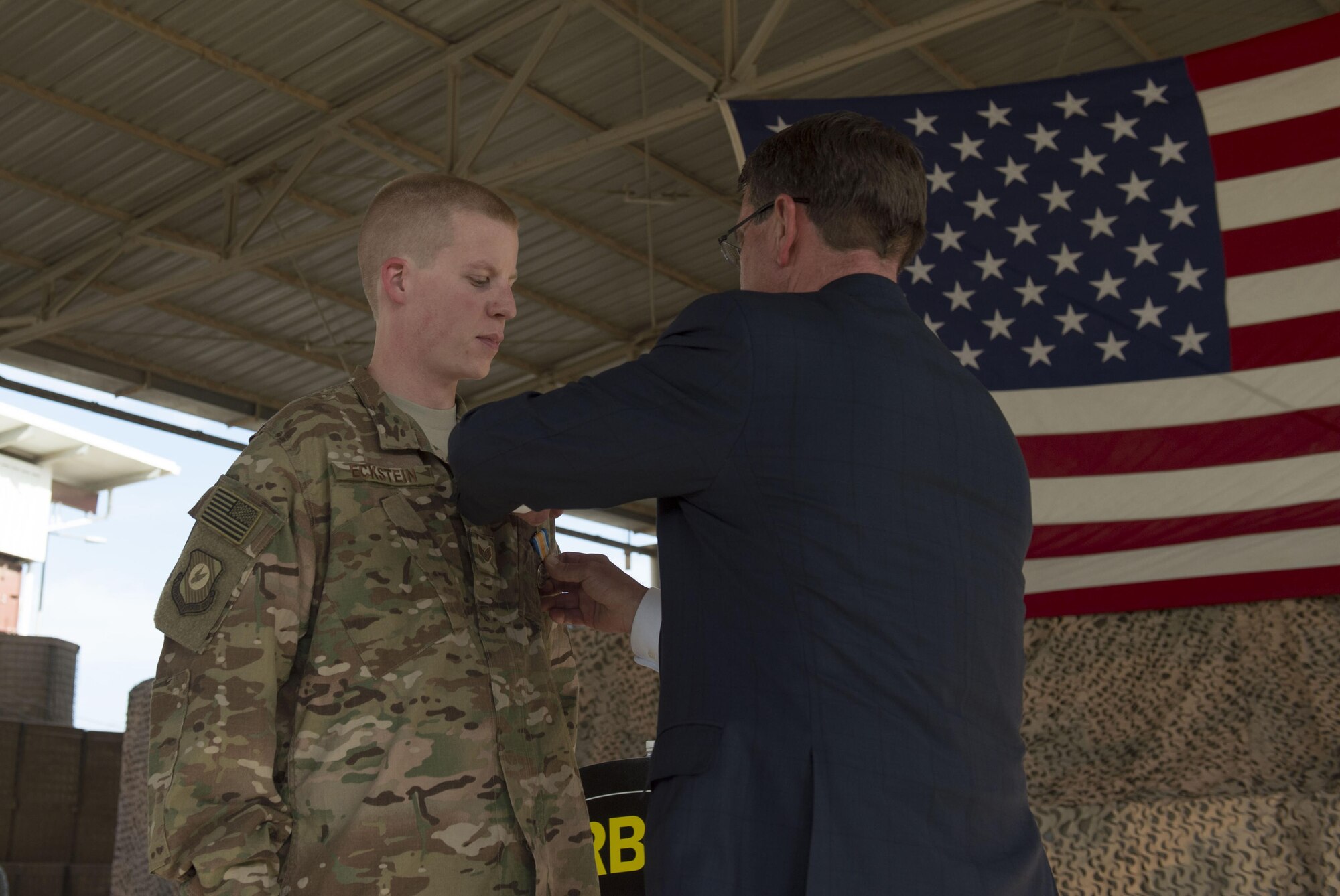 Secretary of Defense Ash Carter pins the Operation Inherent Resolve Campaign Medal on Staff Sgt. Brandon Eckstein, 370th Air Expeditionary Advisory Group. (Photo by Senior Master Sgt. Adrian Cadiz)(Released)