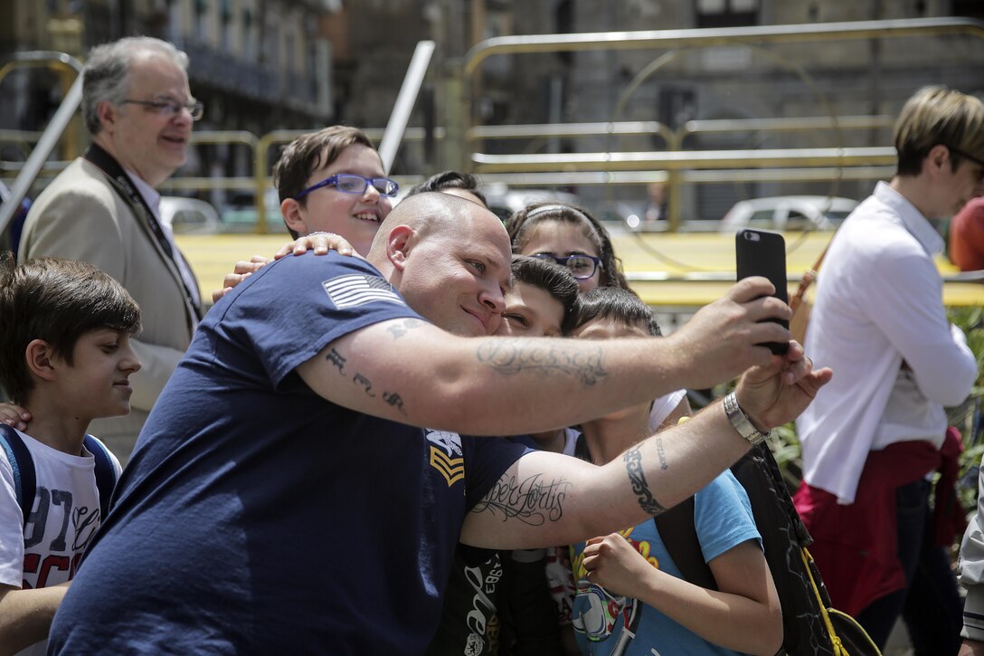 HM1 Scott Reid, a corpsman with the Special Purpose Marine Air-Ground Task Force Crisis Response-Africa, takes a selfie with students during a community project in Nicosia, Italy, May 25, 2016.  Students from Instituto di Istruzione Superiore “Alessandro Volta” were able to practice their English and share their culture while leading Marines and sailors on a tour around Nicosia. (U.S. Marine Corps photo by Cpl. Alexander Mitchell/released)