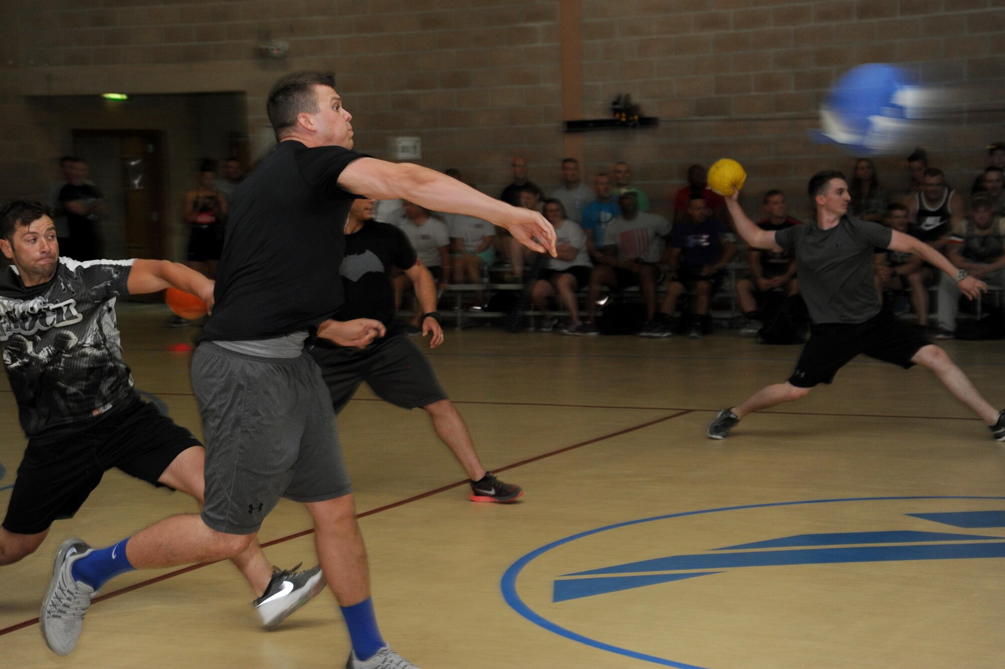 Staff Sgt. Nicholas Hellen, 386th Expeditionary Security Forces Squadron and member of the Raptors, throws the ball during a dodgeball game at an undisclosed location in Southwest Asia, May 29, 2016. The Raptors were one of two teams from the 386 ESFS and won the dodgeball tournament, which was one of the many events featured at Rockfest XIV. (U.S. Air Force photo by Senior Airman Zachary Kee)