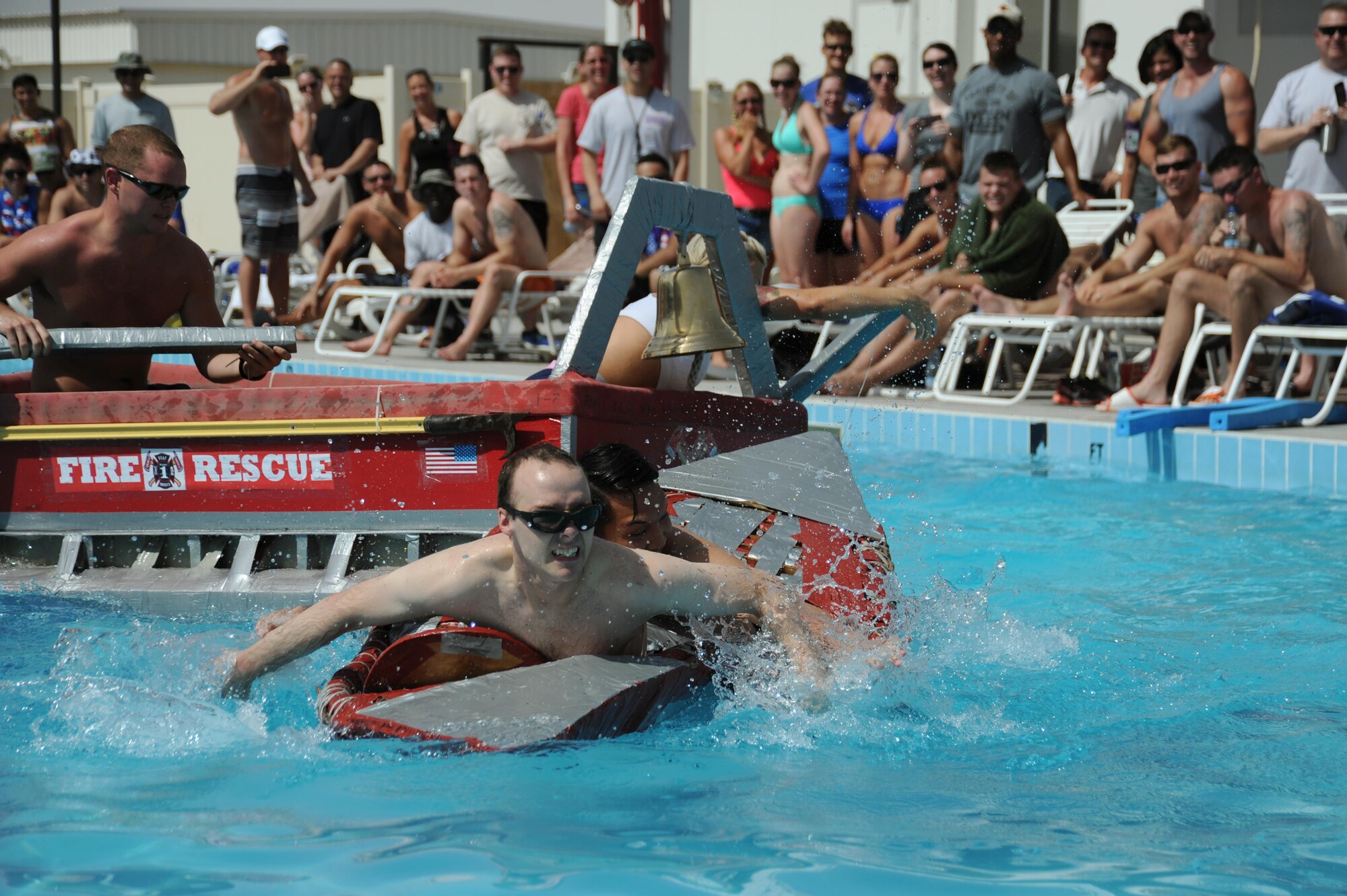 Capt. Robert Klingensmith, front, and Senior Airman Kimrussel Pascual from the 46th Expeditionary Reconnaissance Squadron fight to the finish in their boat “Devil’s Dream” against the Fire Department at an undisclosed location in Southwest Asia, May 29, 2016. Seven teams competed for the fastest time and most creative design in the cardboard-boat regatta during the event Rockfest. (U.S. Air Force photo by Senior Airman Zachary Kee)