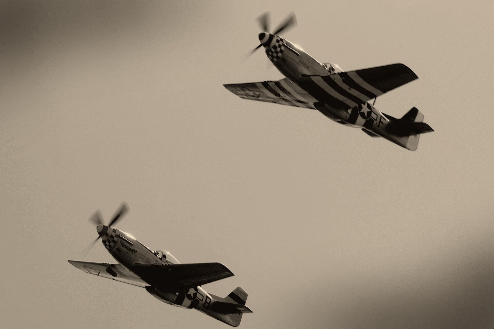 Two P-51 Mustang’s perform a flyover during the unveiling of the 490th Bombardment Group Memorial, May 29, in the village of Brome, England. Over 100 attendees gathered to witness the permanent monument dedicated to the men of the 490th for their contributions during World War II. (U.S. Air Force photo/ Tech Sgt. Matthew Plew)