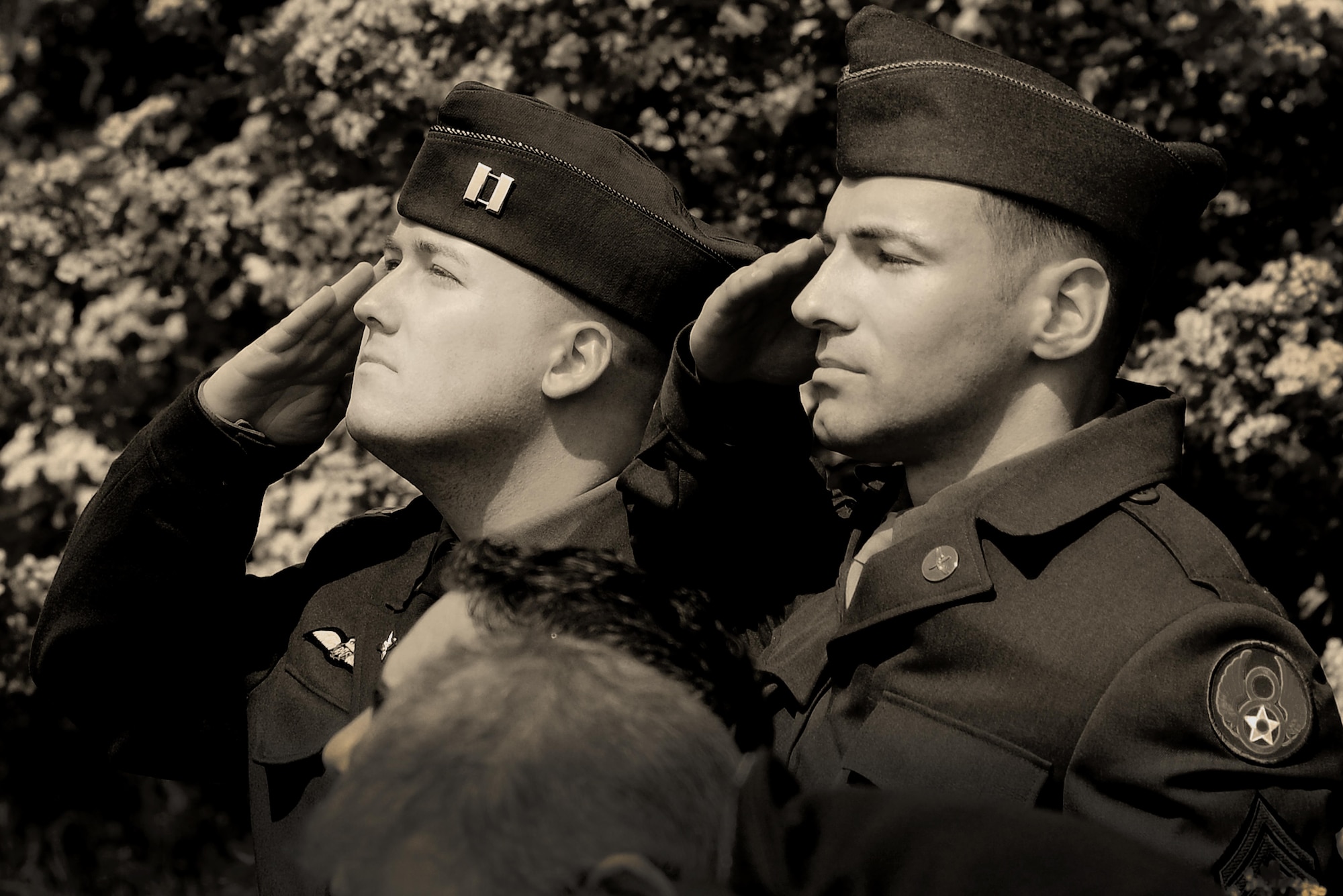 U.S. Air Force Staff Sgt. Scotty Weeks and Tech Sgt. Jaime Sherwood, 48th Fighter Wing aerospace propulsion craftsmen, render a salute to honor the men of the 490th Bomb Group May 29, in the village of Brome, England. Over 100 attendees gathered to witness the permanent monument dedicated to the men of the 490th for their contributions during World War II. (U.S. Air Force photo/ Tech Sgt. Matthew Plew)