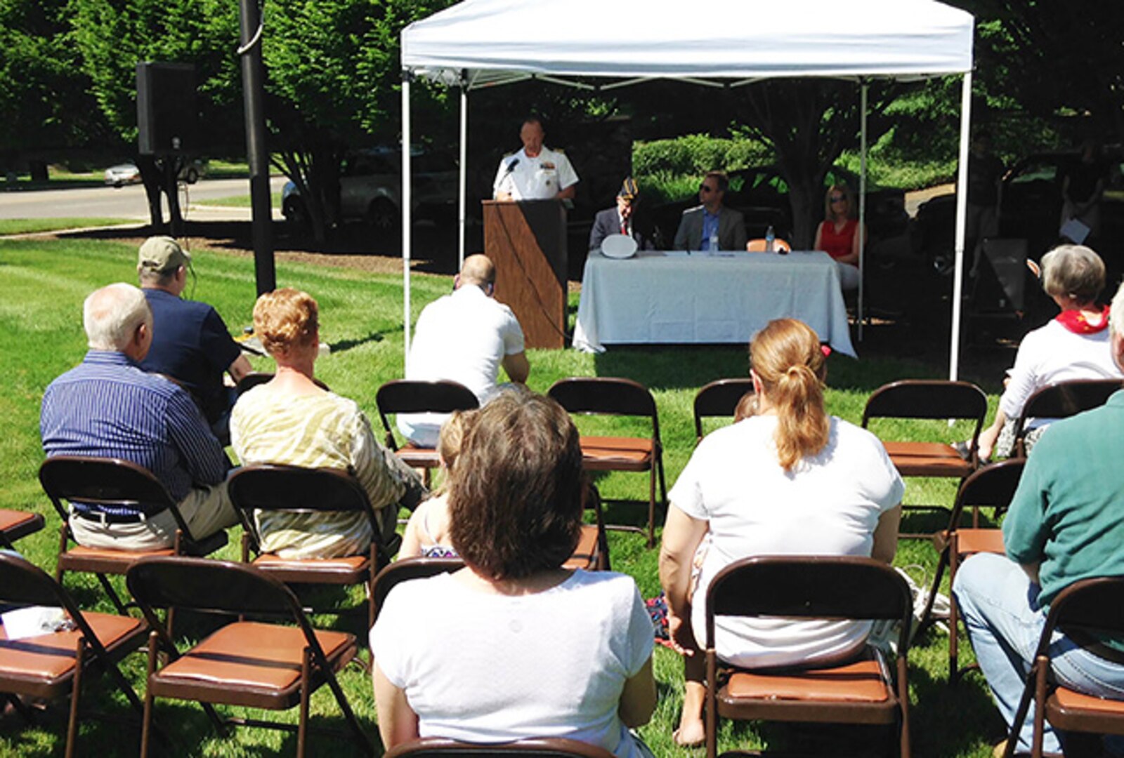 Navy Capt. Brian Ginnane (standing at podium), DLA Land and Maritime Director of Maritime Customer Operations, shares his message with the City of Bexley residents during Bexley’s Memorial Day celebration. 