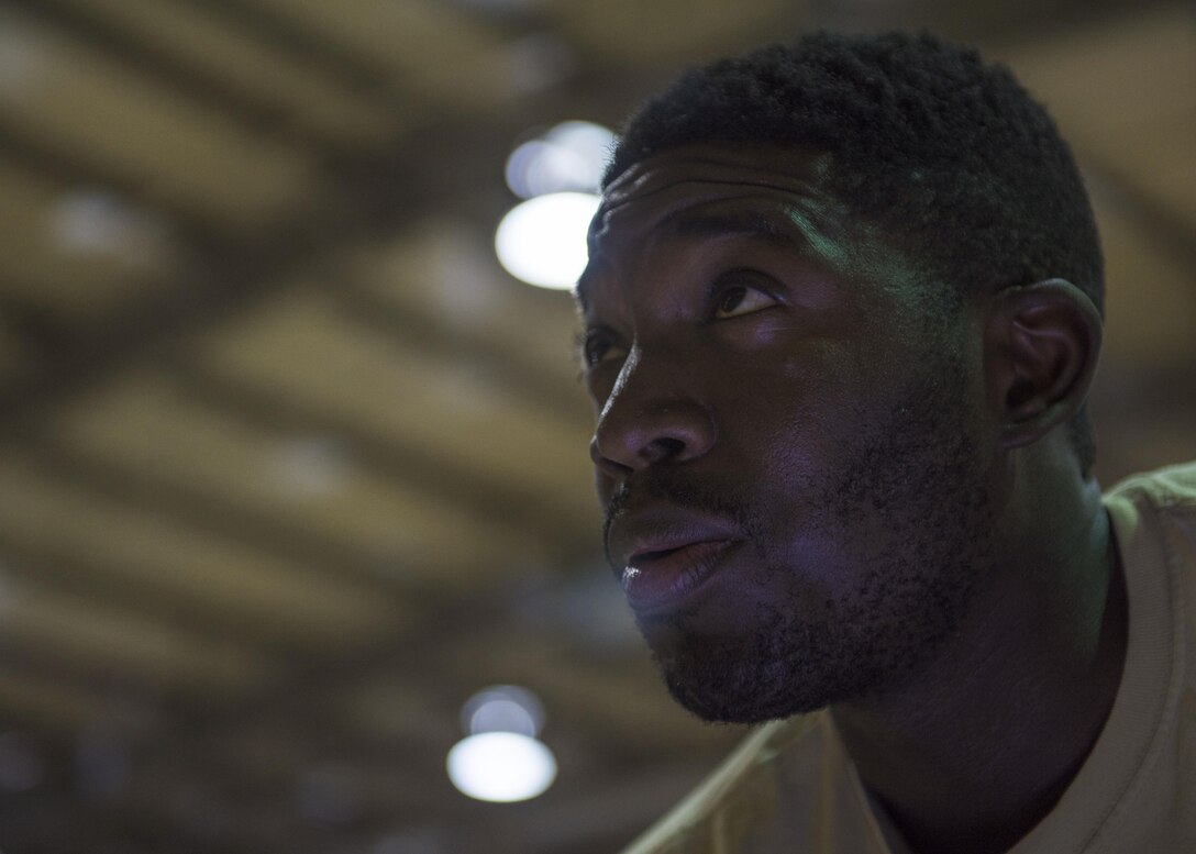 Staff Sgt. Quinton Glover, 455th Expeditionary Aircraft Maintenance Squadron aerospace ground equipment technician, speaks with another Airman as they repair an aircraft tow bar at Bagram Airfield, Afghanistan, May 31, 2016. Bagram has four different AGE units, and each unit is responsible for inspecting, maintaining, and delivering equipment to their sector of the base. (U.S. Air Force photo by Senior Airman Justyn M. Freeman)
