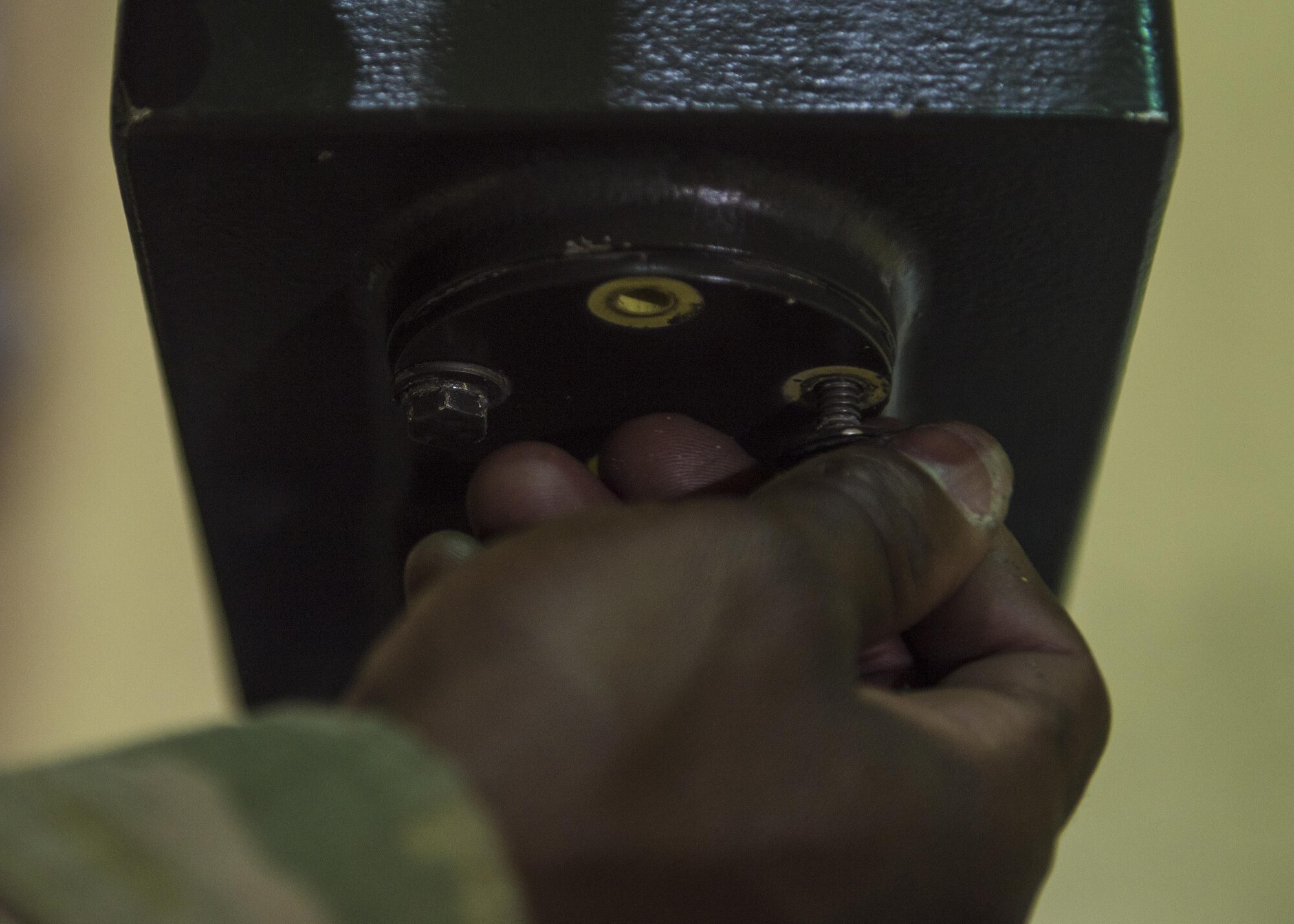 Senior Airman Davon Thompson, 455th Expeditionary Aircraft Maintenance Squadron aerospace ground equipment technician, screws in a bolt while repairing an aircraft tow bar at Bagram Airfield, Afghanistan, May 31, 2016. AGE supports the counter-terrorism mission by providing maintenance service to equipment that supports Bagram’s aircraft. (U.S. Air Force photo by Senior Airman Justyn M. Freeman)