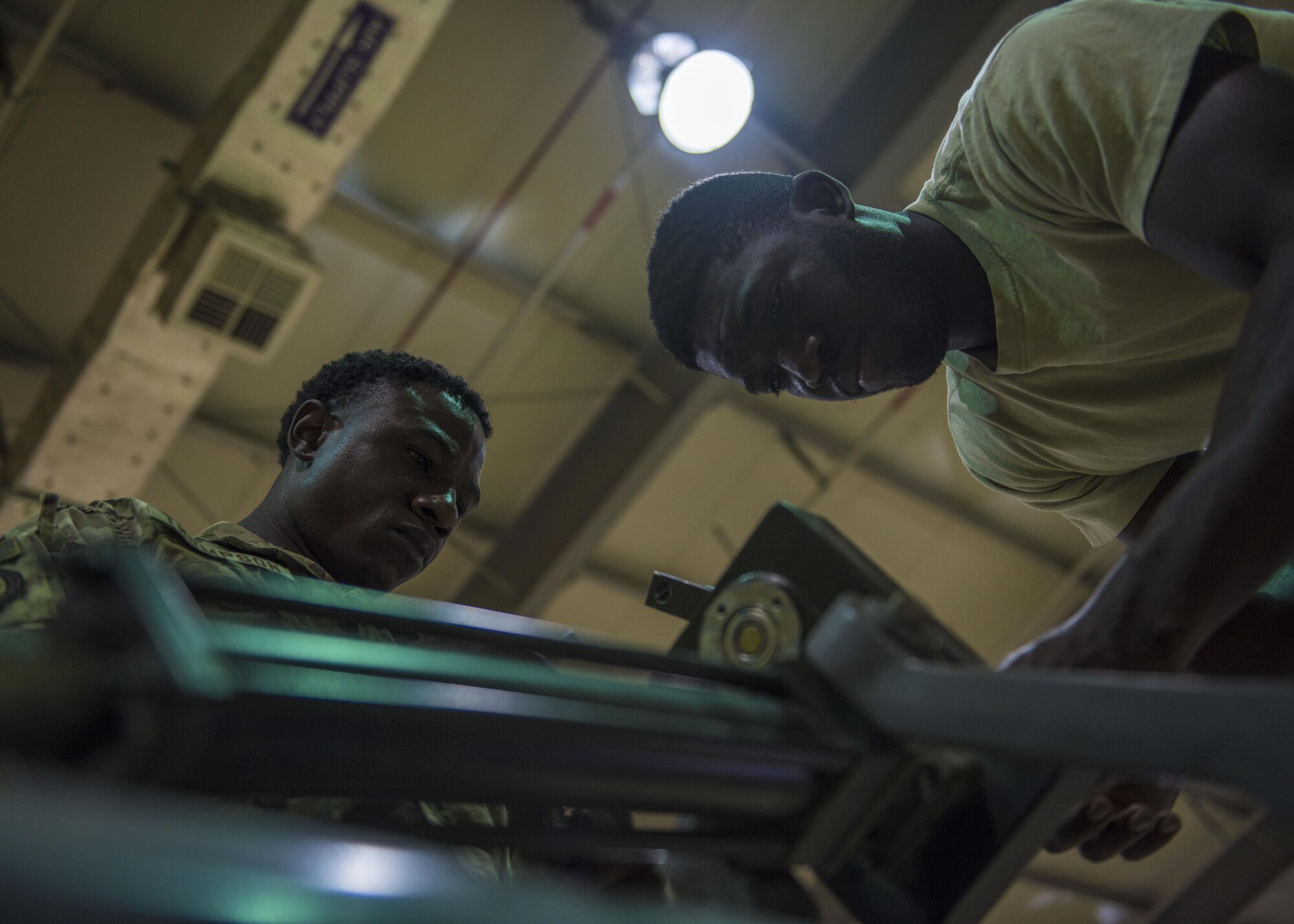 Staff Sgt. Quinton Glover (right) and Senior Airman Davon Thompson (left), 455th Expeditionary Aircraft Maintenance Squadron aerospace ground equipment technicians, repairs an aircraft tow bar at Bagram Airfield, Afghanistan, May 31, 2016. AGE is responsible for maintaining equipment that supplies electricity, hydraulic pressure and air conditioning to aircraft. (U.S. Air Force photo by Senior Airman Justyn M. Freeman)