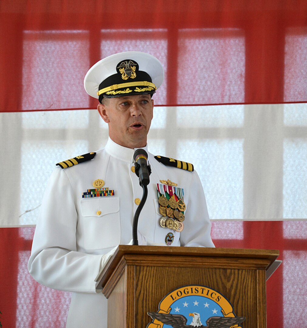 Navy Cmdr. Maurice Meagher, III speaks to the audience gathered for the Defense Logistics Agency Aviation at Jacksonville change of command and his retirement ceremony May 25,  2016 at Hangar 117, Naval Air Station Jacksonville, Florida.