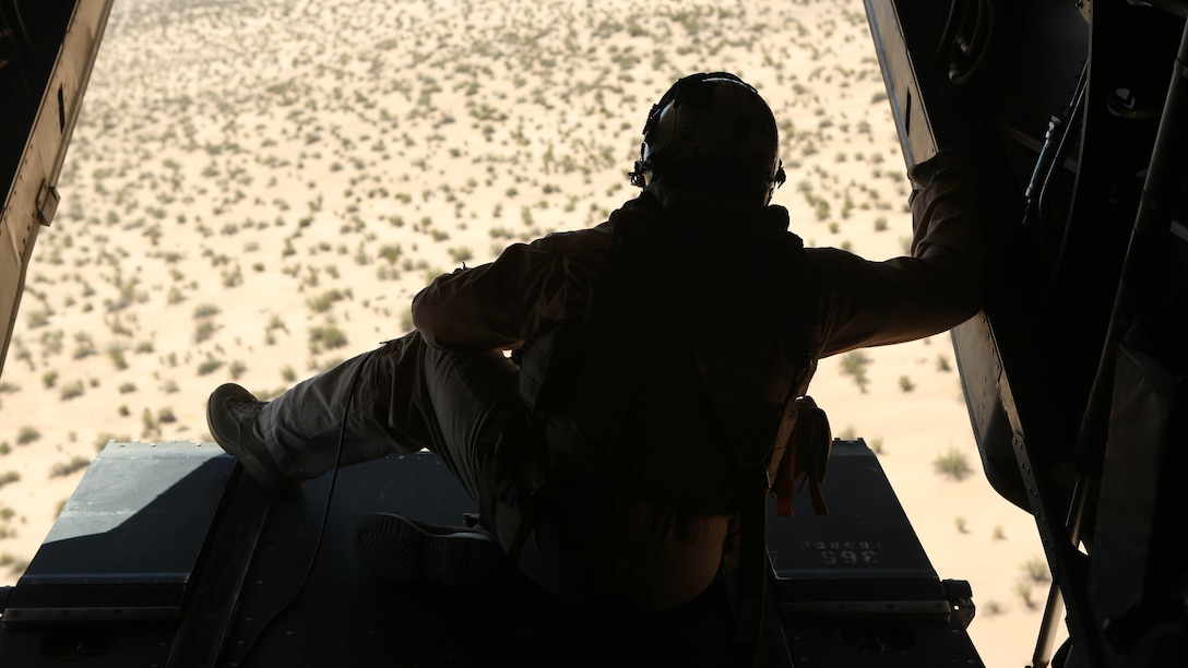 A Marine with Marine Medium Tiltrotor Squadron (VMM) 364 “Purple Foxes” checks the rear of an MV-22B Osprey during section and division confined area landings at Holtville Airfield, Calif., May 20. The training was conducted to familiarize both pilots and crew chiefs with landing in a small area around other aircraft. 