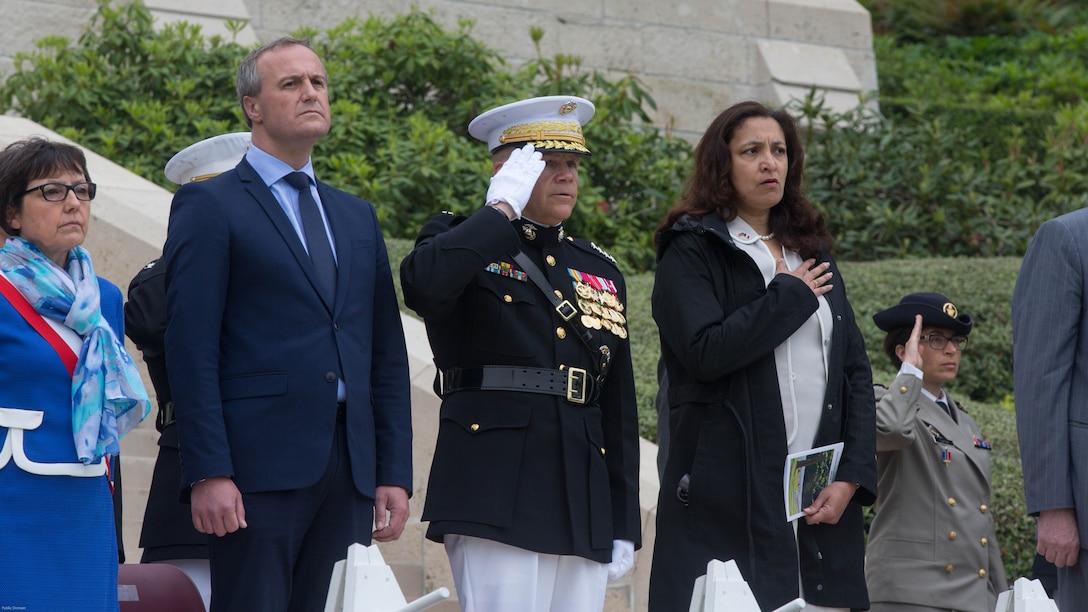 Members of the official party, including General Robert B. Neller, Commandant of the Marine Corps, salute during a Memorial Day ceremony in which U.S. Marines performed alongside the French Army at the Aisne-Marne American Memorial Cemetery in Belleau, France, May 29, 2016. The French and the Americans gathered together, as they do every year, to honor those service members from both countries who have fallen in WWI, Belleau Wood and throughout history, fighting side by side. The Marines also remembered those they lost in the Battle of Belleau Wood 98 years ago.