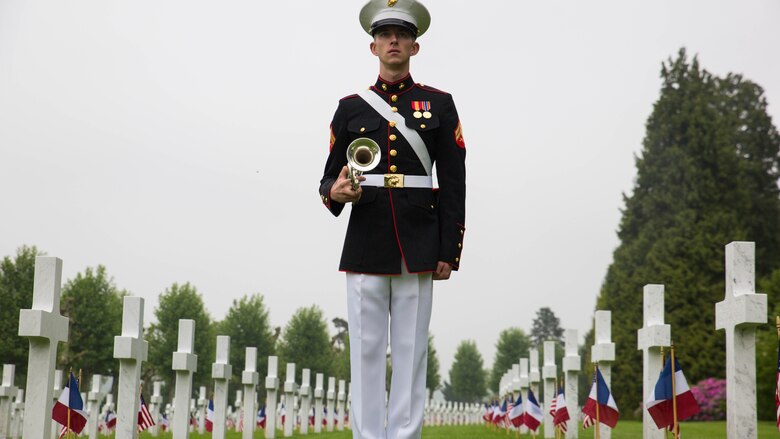 Cpl. Lucas DeValder, trumpet player with 2nd Marine Division band, stands at attention during a Memorial Day ceremony in which U.S. Marines performed alongside the French Army at the Aisne-Marne American Memorial Cemetery in Belleau, France, May 29, 2016. The French and the Americans gathered together, as they do every year, to honor those service members from both countries who have fallen in WWI, Belleau Wood and throughout history, fighting side by side. The Marines also remembered those they lost in the Battle of Belleau Wood 98 years ago.