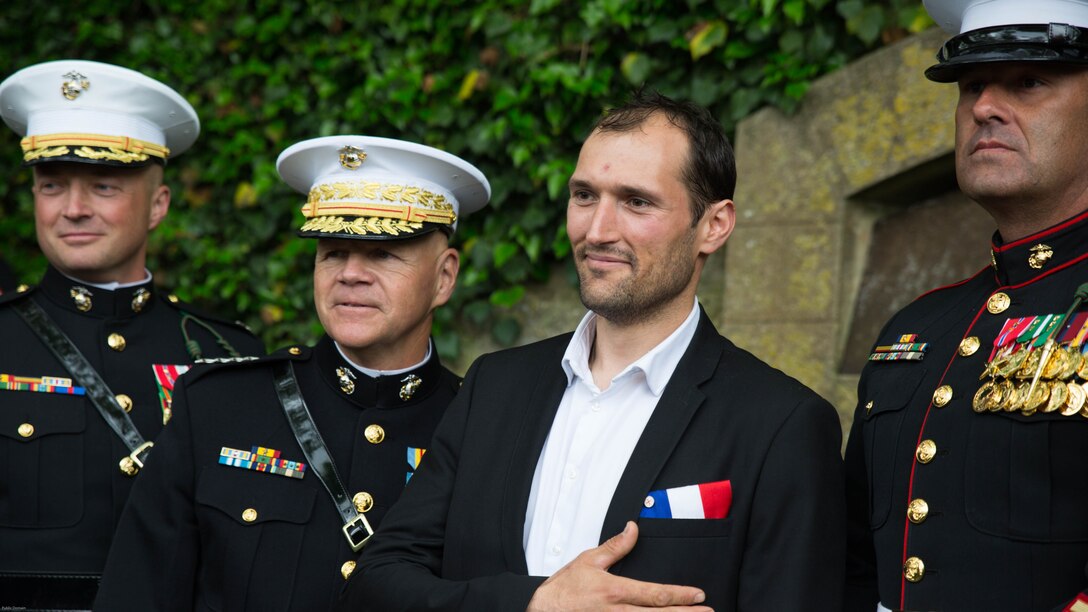 Gen. Robert B. Neller (left-center), Commandant of the Marine Corps, and other Marines take a picture with a Frenchman after a Memorial Day ceremony in which U.S. Marines performed alongside the French Army at the Aisne-Marne American Memorial Cemetery in Belleau, France, May 29, 2016. The French and the Americans gathered together, as they do every year, to honor those service members from both countries who have fallen in WWI, Belleau Wood and throughout history, fighting side by side. The Marines also remembered those they lost in the Battle of Belleau Wood 98 years ago.