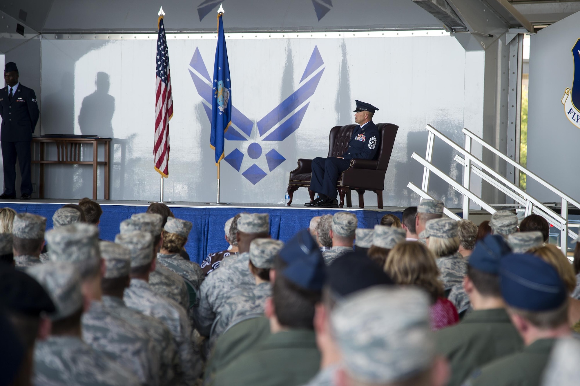 U.S. Air Force Chief Master Sgt. David Kelch, 23d Wing command chief, listens as Brig. Gen. Chad Franks, senior executive officer to the Air Force vice chief of staff, gives his remarks during a retirement ceremony at Moody Air Force Base, Ga., May 26, 2016. Franks thanked Kelch for all his hard work and dedication during their time working together at the 23d WG.. (U.S. Air Force photo by Airman 1st Class Janiqua P. Robinson/Released)