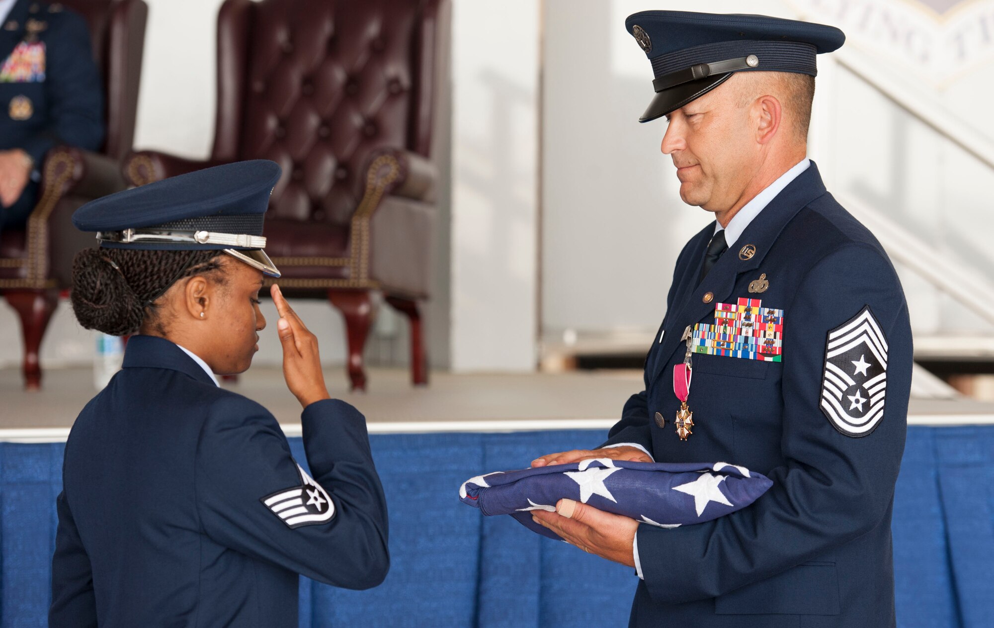 U.S. Air Force Staff Sgt. Latosha Ross, 23d Force Support Squadron base honor guard, salutes the flag after presenting it to U.S. Air Force Chief Master Sgt. David Kelch, 23d Wing command chief, during his retirement ceremony at Moody Air Force Base, Ga., May 26, 2016. Kelch, who has served as the 23d WG's command chief since July of 2014, retired after 29 years and seven months of military service. (U.S. Air Force photo by Andrea Jenkins/Released)