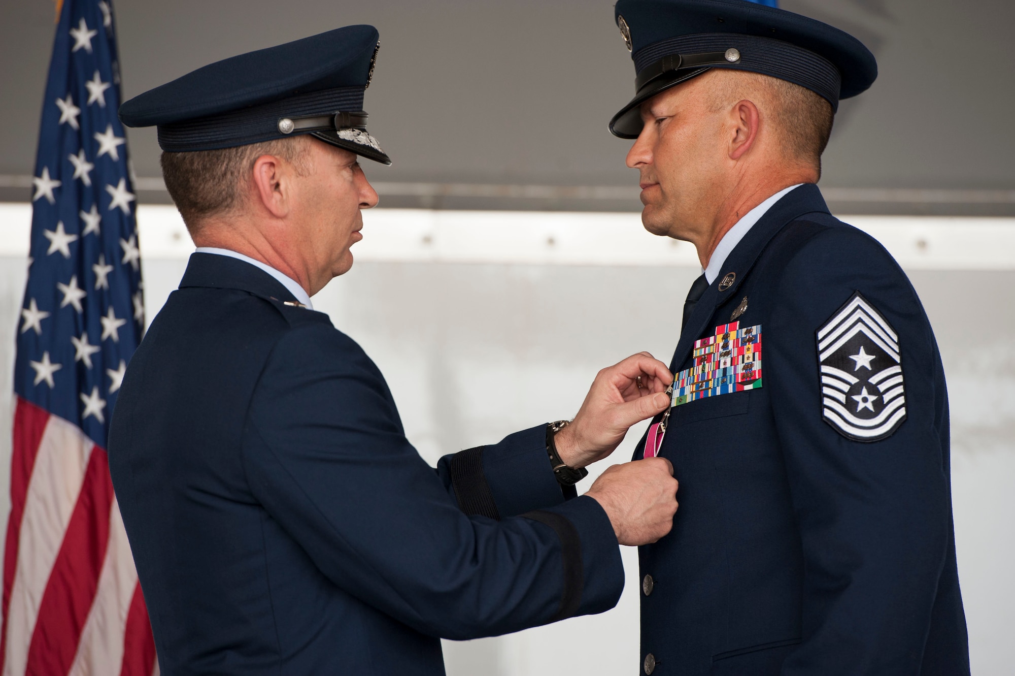 U.S. Air Force Brig. Gen. Chad Franks, senior executive officer to the Air Force vice chief of staff, pins the Legion of Merit medal on Chief Master Sgt. David Kelch, 23d Wing command chief, during a retirement ceremony at Moody Air Force Base, Ga., May 26, 2016. The Legion of Merit is awarded to members of the armed forces who have distinguished themselves by exceptionally meritorious conduct in the performance of outstanding service. (U.S. Air Force photo by Andrea Jenkins/Released)