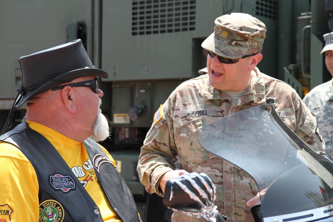 Major Harold Aprill, the executive officer for the 3rd Battalion, 399th Regiment, speaks to one of the motorcyclists who took part in the 13th annual Support the Troops Ride during the 2016 Armed Forces Day celebration at the Milwaukee, Wis. Harley-Davidson Museum, May 21, 2016.  Aprill, who is also a member on the Milwaukee Armed Services Committee, helped organize the event which capped off an entire week of activities for Milwaukee's Armed Forces Week.   Aprill and reservists from the 3/399th, as well as volunteers from the other branches, helped raise military awareness by displaying military vehicles and explaining to civilians their current role in supporting ongoing military efforts around the world. Service members past and present mingled with the crowd throughout the day.