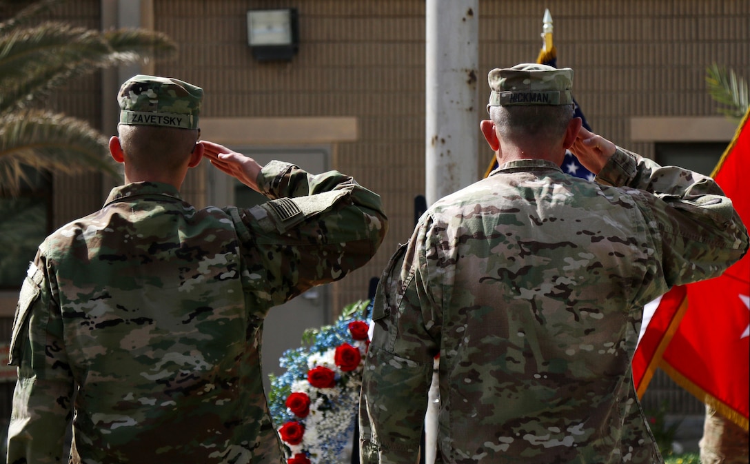 Maj. Gen. William Hickman, the deputy commanding general – operations for U.S. Army Central and Pvt. Zachary Zavetsky, an USARCENT soldier from Leland, NC, salute during the Memorial Day Service hosted by USARCENT and the Area Support Group – Kuwait on May 30, 2016 at Camp Arifjan, Kuwait. The Memorial Day service honors fallen Servicemembers. (Photo by Spc. Angela Lorden/Released)