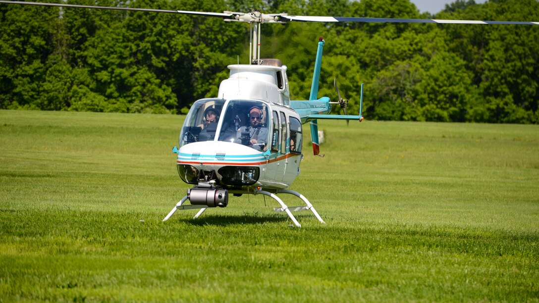 Pilots supervise a Bell 206 helicopter during tests of the attached Autonomous Aerial Cargo/Utility System in Bealeton, Virginia, May 25, 2016. Pilots make sure that the system can run smoothly and perform maneuvers the same way a human controlling it would. 