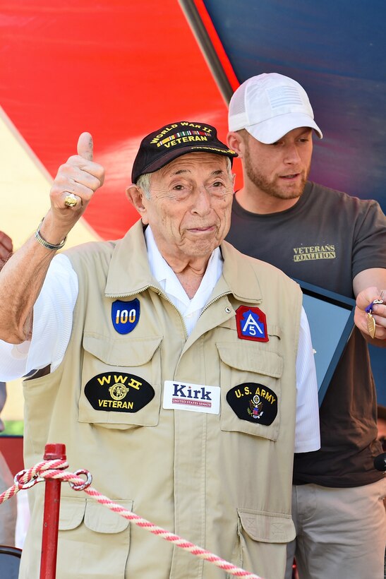 World War II Veteran Irving M. Abramson gives a thumbs-up during a story recounting a kiss he received, from actress Marlene Dietrich, while he recovered from wounds inflicted during the Battle of the Bulge. Abramson received the Purple Heart and other medals for his service during World War II at the Arlington Heights’ Memorial Day commemoration, May 30, 2016.  
(U.S. Army photo by Sgt. Aaron Berogan/Released)