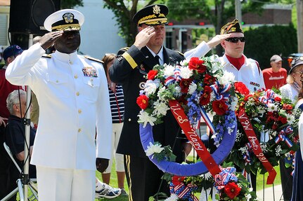 From left to right: Rear Admiral Stephen Evans, Commander, Naval Services Training Command, Naval Station Great Lakes; Brig. Gen. Frederick R. Maiocco Jr., Commanding General, 85th Support Command, Arlington Heights, Illinois; and Mike Mclnerney, Post Commander, Arlington Heights VFW Post 981, Arlington Heights, Illinois, salute during a wreath laying ceremony at the Arlington Heights’ Memorial Day parade, May 30, 2016. 
(U.S. Army photo by Spc. David Lietz/Released)