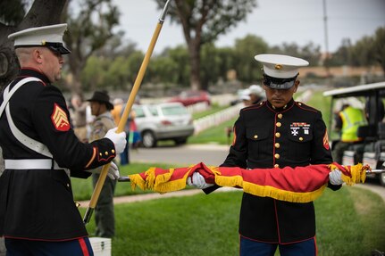 Marine Corps Sgt. Michael Vopal and Cpl. Christian Navarro, 2nd Battalion, 23rd Marines, 4th Marine Division, U.S. Marine Corps Forces Reserve, prepare the Marine Corps colors for transportation following a moving Memorial Day ceremony at the Los Angeles National Ceremony, Los Angeles, Calif., May 30, 2016.