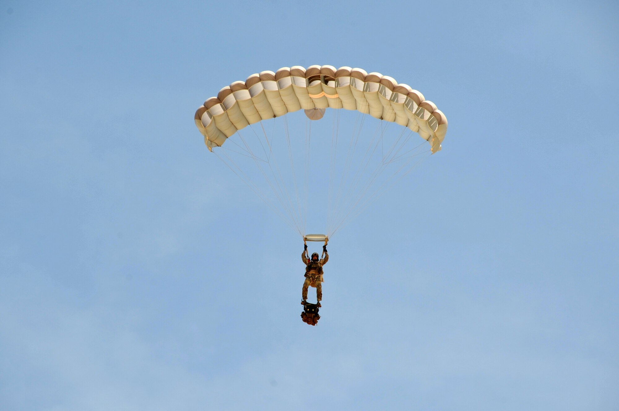A pararescueman assigned to the 306th Rescue Squadron descends on Eloy, Ariz., during training May 14. Air Force pararescuemen, also known as PJs, are the only Department of Defense elite combat forces specifically organized, trained, equipped and postured to conduct full-spectrum personnel recovery to include both conventional and unconventional combat rescue operations. These battlefield Airmen are the most highly trained and versatile personnel recovery specialists in the world. Pararescue is the nation's force of choice to execute the most perilous, demanding and extreme rescue missions anytime, anywhere across the globe.  (U.S. Air Force photo by Tech. Sgt. Carolyn Herrick)