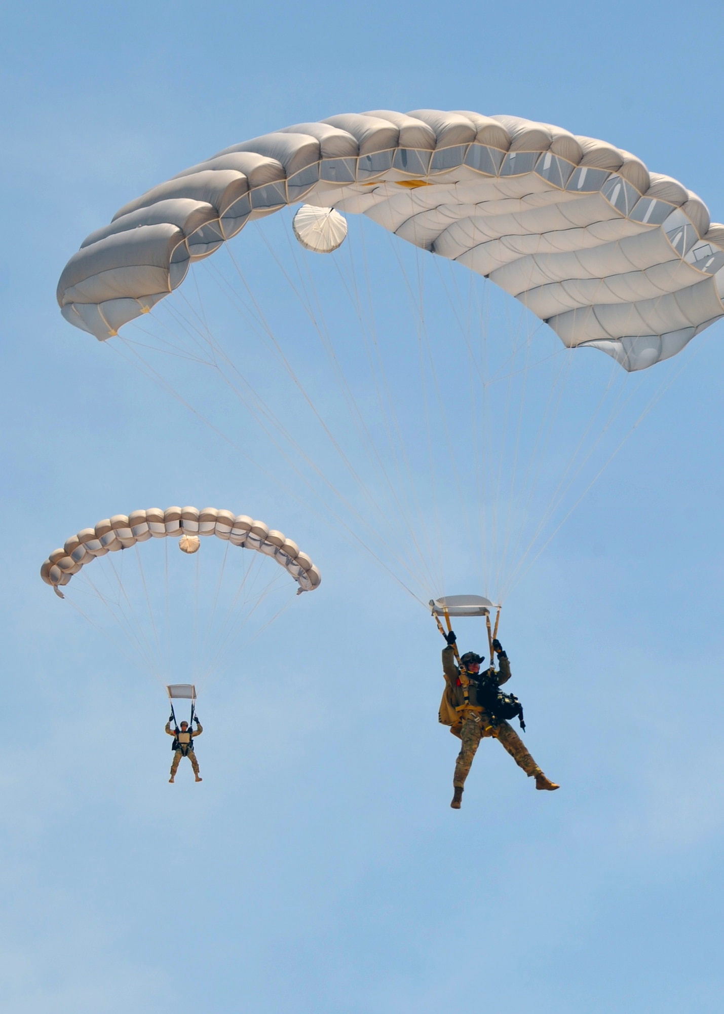 Pararescuemen from the 306th Rescue Squadron at Davis-Monthan Air Force Base, Ariz., descend on Eloy, Ariz., during training jumps May 14. The 306th RQSis an Air Force Reserve Command combat search and rescue unit assigned to the 943rd Rescue Group. Pararescuemen, also known as PJs, are the only Department of Defense elite combat forces specifically organized, trained, equipped and postured to conduct full-spectrum personnel recovery to include both conventional and unconventional combat rescue operations. These battlefield Airmen are the most highly trained and versatile personnel recovery specialists in the world. (U.S. Air Force photo by Tech. Sgt. Carolyn Herrick)