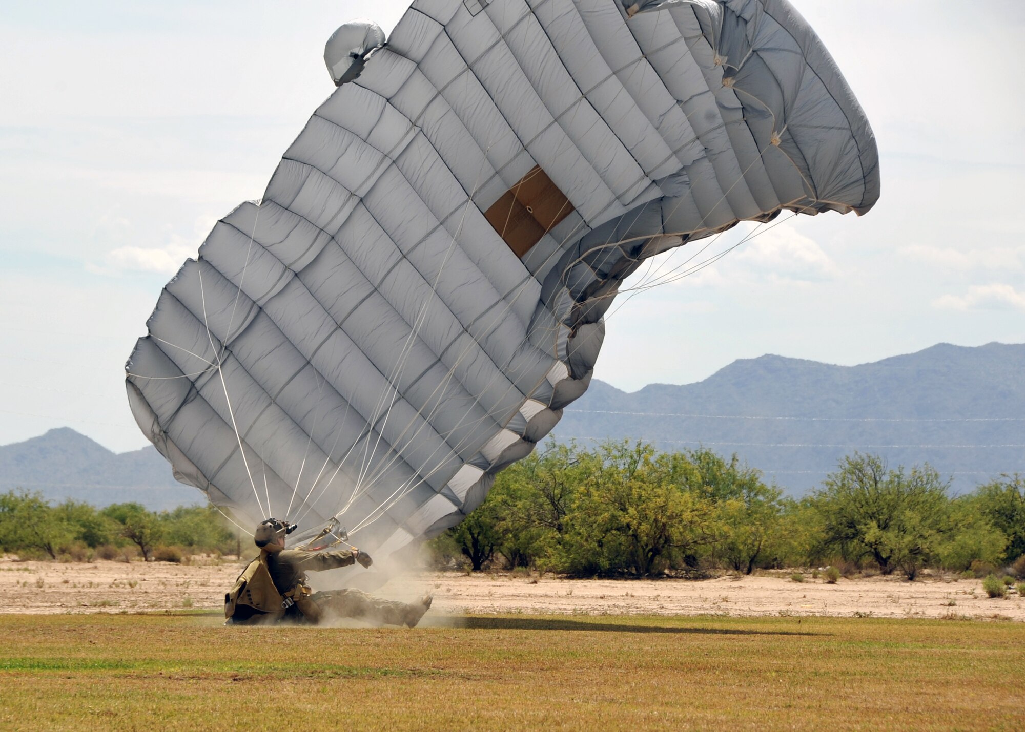 A U.S. Air Force Reserve pararescueman from the 306th Rescue Squadron lands in a skydiving field in Eloy, Ariz., during training May 14. Pararescuemen, also known as PJs, are the only Department of Defense elite combat forces specifically organized, trained, equipped and postured to conduct full-spectrum personnel recovery to include both conventional and unconventional combat rescue operations. These battlefield Airmen are the most highly trained and versatile personnel recovery specialists in the world. (U.S. Air Force photo by Tech. Sgt. Carolyn Herrick)