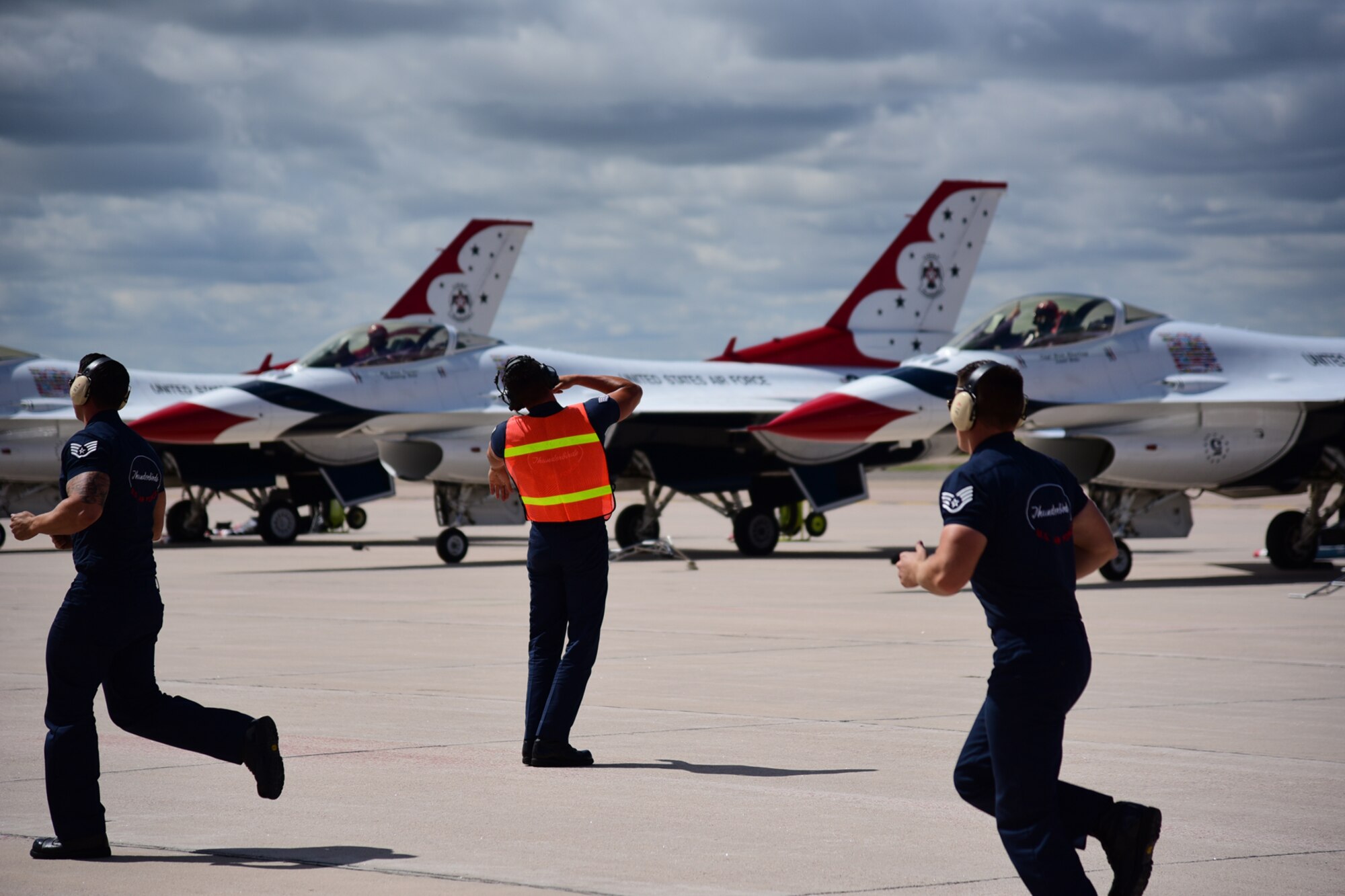 Crew Chiefs run to take their position as the final preparations are completed prior to take off for the U.S. Air Force Thunderbirds from Peterson Air Force Base, Colo., May 31, 2016. The Thunderbirds have performed their precision aerial maneuvers for more than 300 million people around the world. (U.S. Air Force photo by Staff Sgt. Amber Grimm)