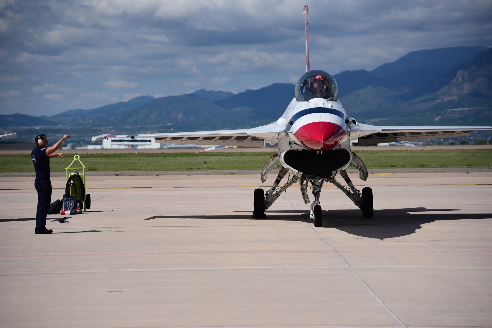 Capt. Ryan Bodenheimer, U.S. Air Force Thunderbird’s left wing, and one of his dedicated crew chiefs exchange hand signals during preflight preparations on Peterson Air Force Base, Colo., May 31, 2016. The Thunderbirds are gearing up to perform a flyover at the United States Air Force Academy graduation. (U.S. Air Force photo by Staff Sgt. Amber Grimm)