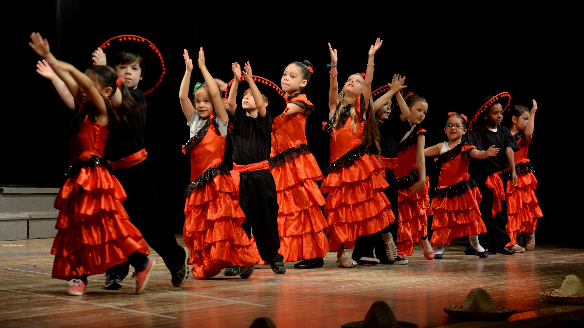 Aviano Elementary School kindergarteners perform the flamenco dance during the end-of-year celebration, June 1, 2016, at Aviano Air Base, Italy. The students learned about the cultures and languages from Chile, Columbia, Mexico, Spain and the Dominican Republic in preparation for the performance. (U.S. Air Force photo by Airman 1st Class Cary Smith/Released)