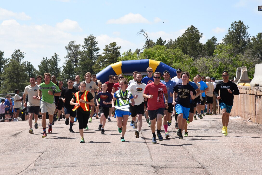 Runners take off from the starting line at the Cheyenne Mountain Air Force Station 5k Tunnel Run/Open House at Cheyenne Mountain Air Force Station, Colo., on May 26, 2016. Known as America’s Fortress, CMAFS celebrates its 50th year as an operational Air Force Station. (U.S. Air Force photo by Airman 1st Class Dennis Hoffman)